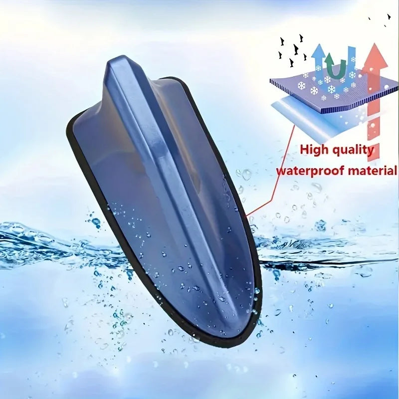 A blue aerodynamic shark fin car antenna with a signal amplifier shown submerged in water.
