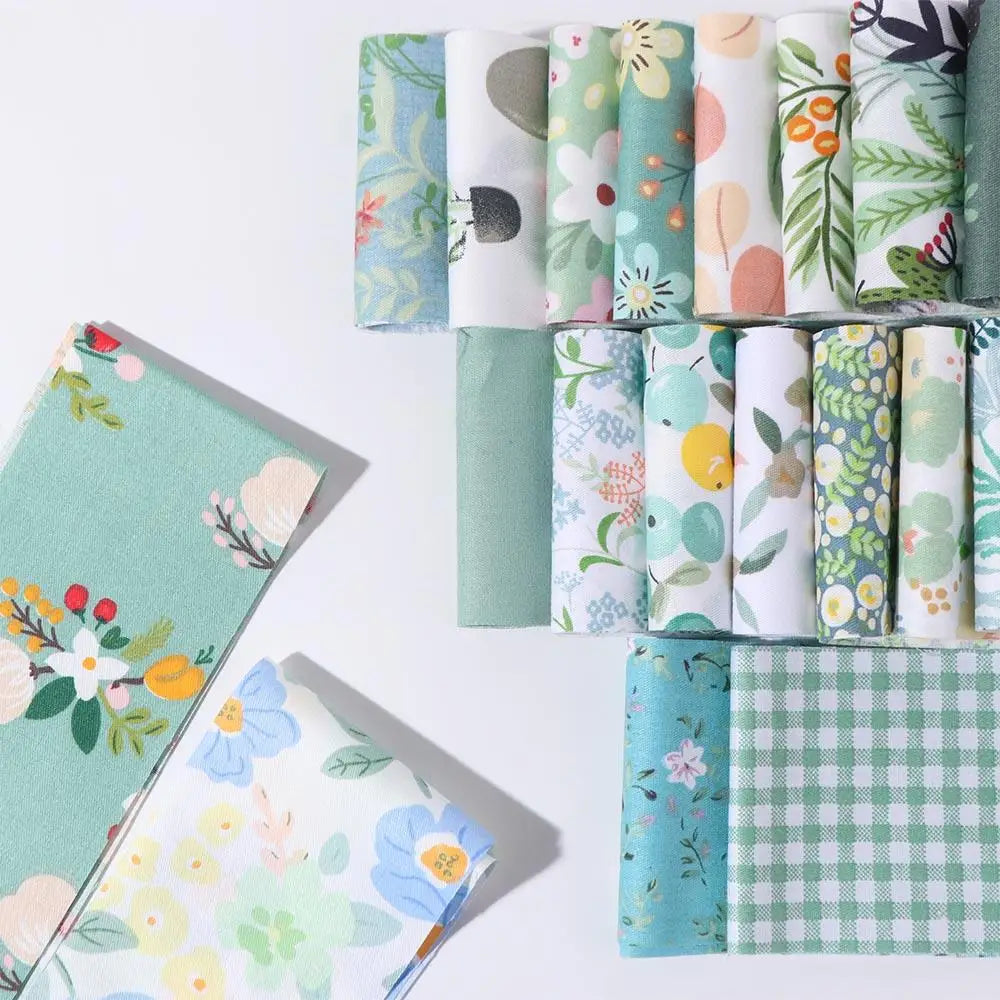 A collection of 40 floral cotton fabric strips in various patterns and colors for quilting and patchwork.