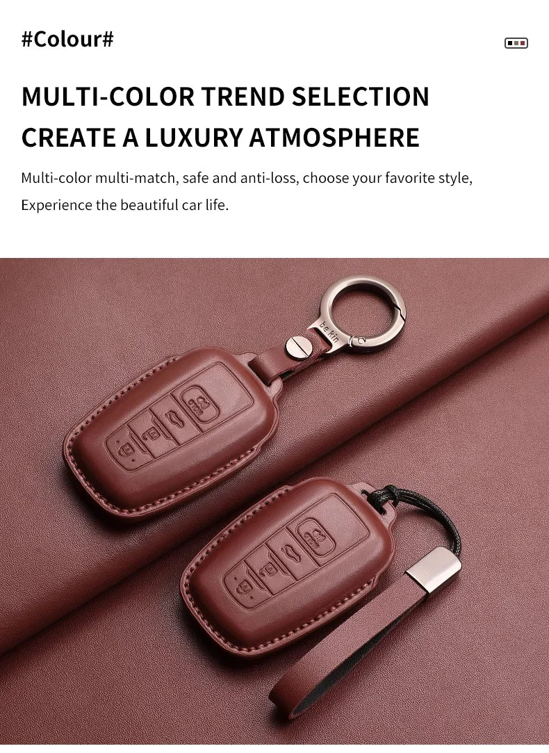 A brown genuine leather car key case cover is shown resting on a dark red fabric surface.