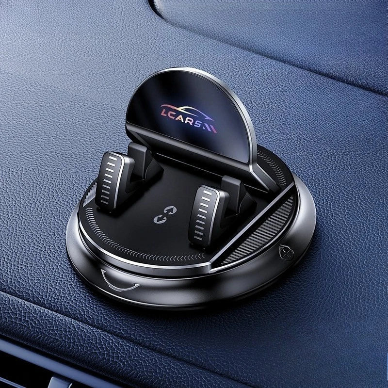 A black anti-slip dashboard phone mount with a rotating mechanism is shown on a dark blue car interior.