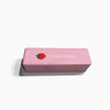 A pink butter fidget stick squishy toy with a strawberry design.