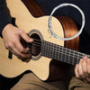 A hand plays a classical guitar with silver-plated nylon strings and a white string loop.