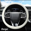 Beige soft silicone steering wheel cover inside a car