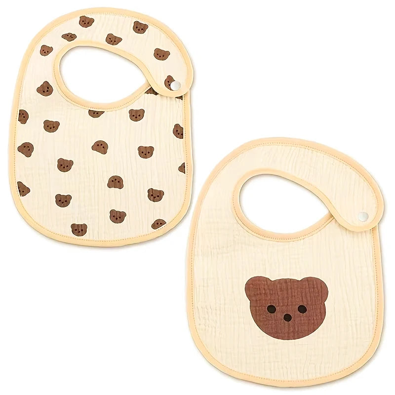 A pair of light beige baby cotton gauze bibs with brown bear patterns and waterproof backing.