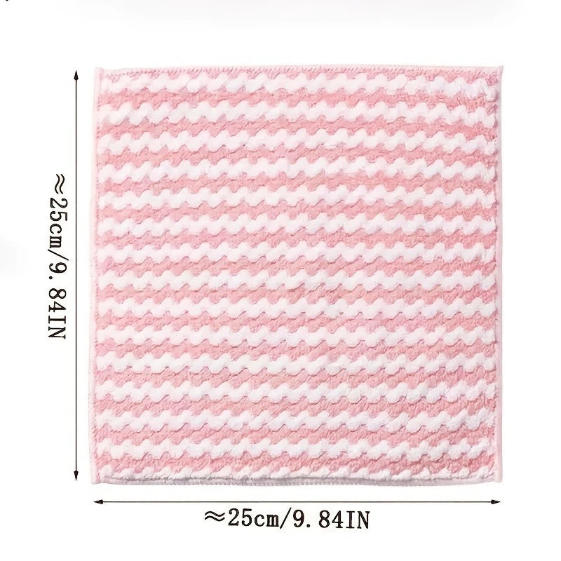 A square pink microfiber kitchen cleaning cloth with a white chevron pattern.