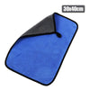 A blue microfiber car drying towel with a black grip and a gray top section.