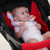 A baby is seated in a car seat with an orange patterned head and neck support pillow.