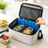 A white reusable cooler box with a black lid and blue gel ice blocks is shown open on a countertop.