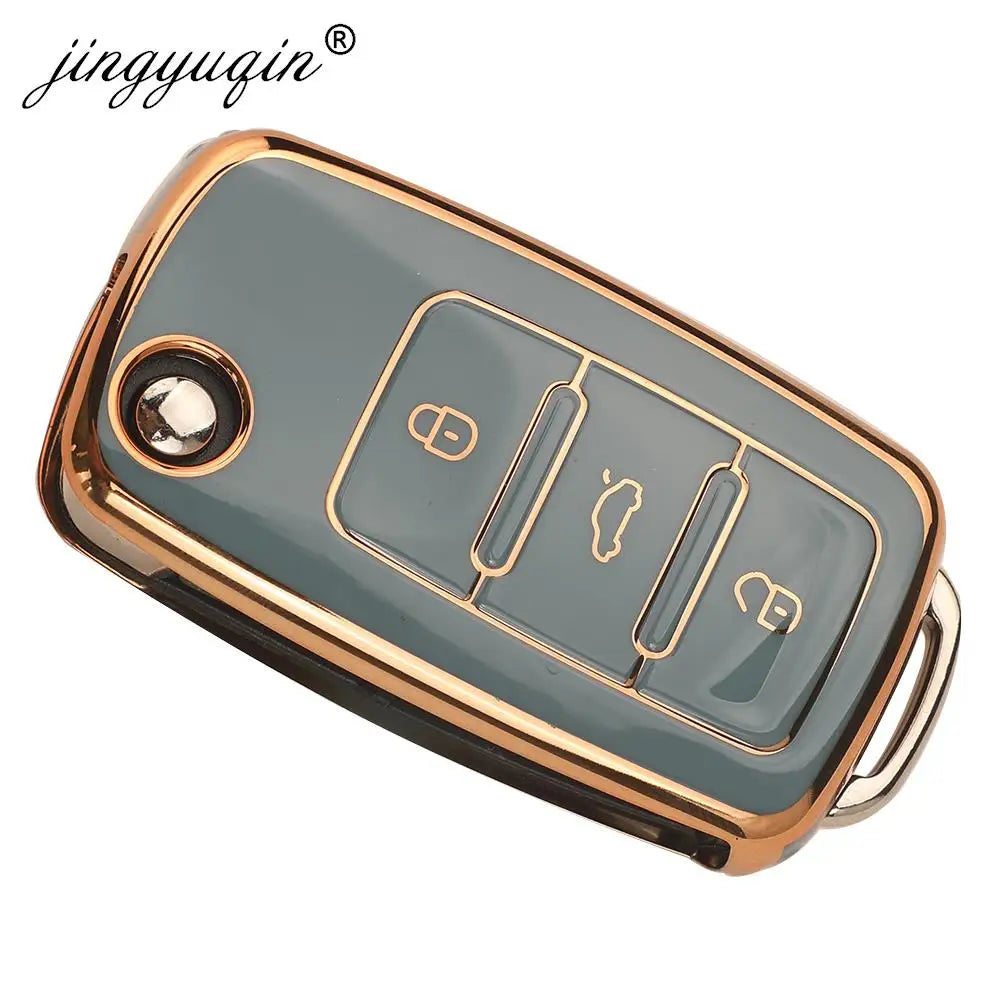 A sleek, gold-edged silicone car key case with a translucent gray body and three key slots.
