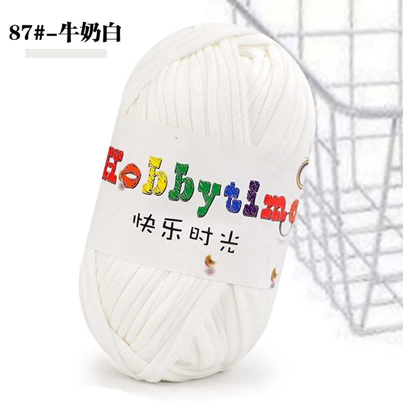 White soft T-shirt yarn for crochet and knitting used in a basket-like mesh background.