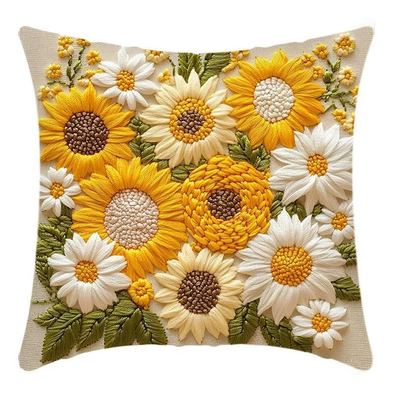A cushion cover featuring a detailed floral design of yellow and white sunflowers on a beige fabric.