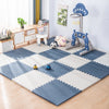 A blue and white interlocking foam play mat with various toys like animals and a climbing structure for babies and toddlers.