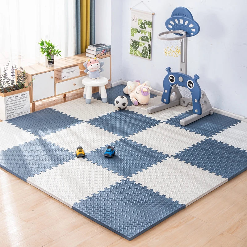 A blue and white interlocking foam play mat with various toys like animals and a climbing structure for babies and toddlers.