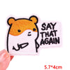 A pink embroidered patch featuring a cartoon tiger face with black outlines and yellow fur, with the text SAY THAT AGAIN.
