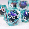 A close-up of a teal liquid core resin die showing the number 20 with a purple dragon eye design.