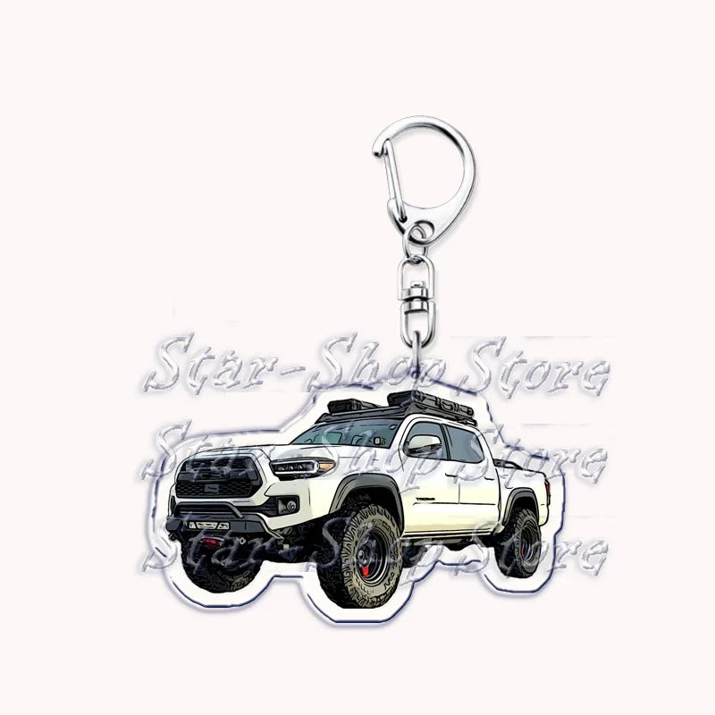 A silver metal key ring attached to a durable keychain featuring an off-road truck model.