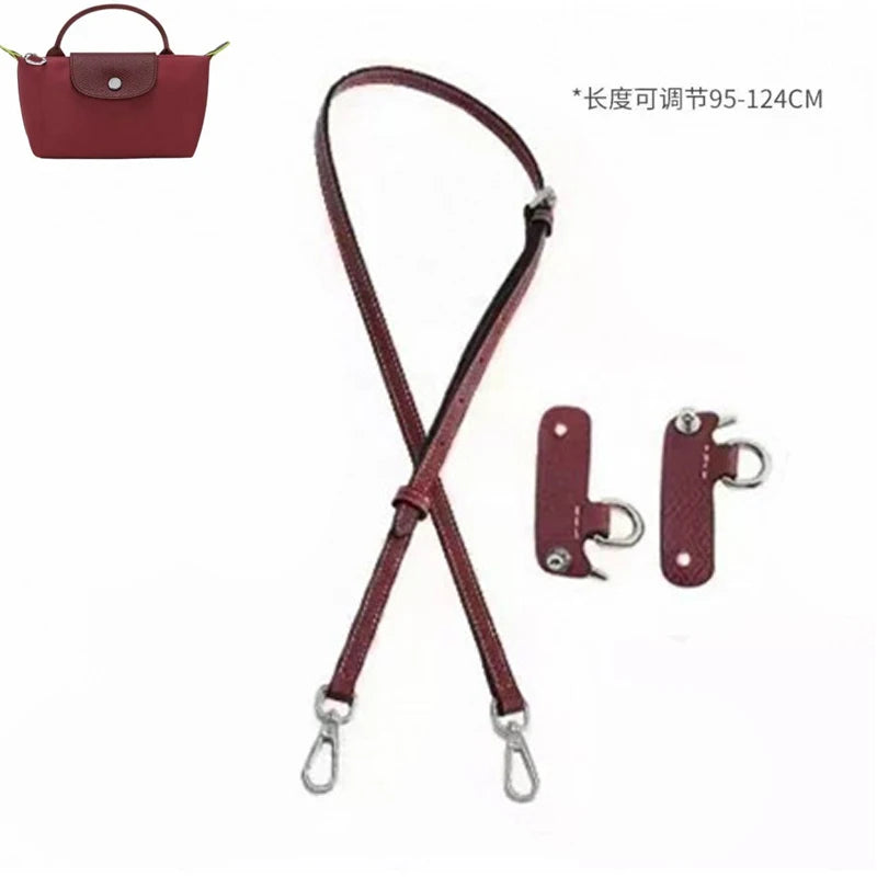 A maroon leather shoulder strap and hardware for mini bags.