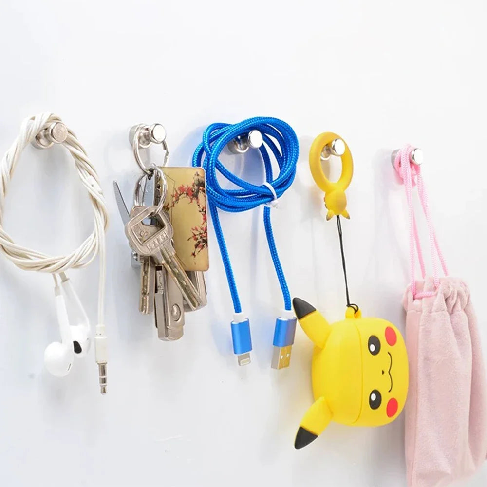Neodymium magnetic pushpins in various colors including silver, blue, and yellow attached to a white background