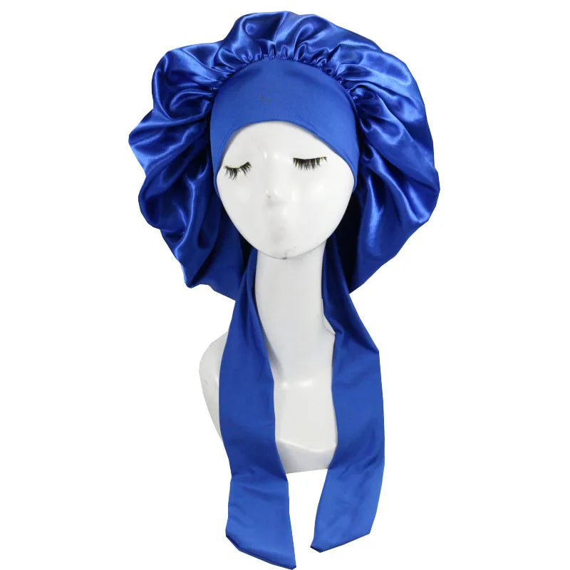 A royal blue satin sleep cap draped around a mannequin's head.