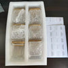 A white foam tray holds five square glass spice jars with bamboo lids and labels for various spices.
