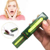 A hand holds a green piece of cockroach prank gum with a woman looking surprised in the background.