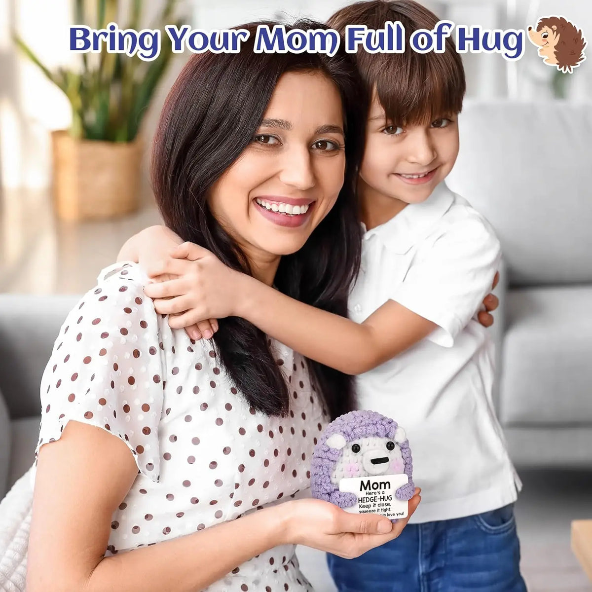 A mother hugs her son while holding a handmade crochet hedgehog doll with an inspirational card.