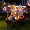 A family enjoying an outdoor dinner under string lights with colorful LED fairy lights illuminating the scene.