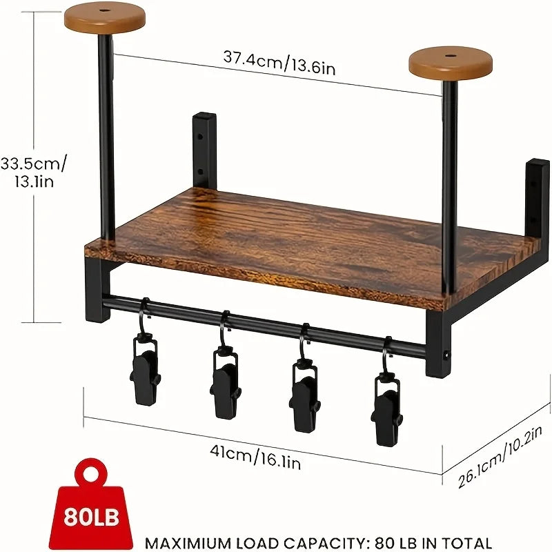 A black motorcycle helmet wall mount featuring a wooden shelf and four hanging hooks for storage.
