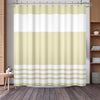 A beige and white striped waffle weave shower curtain hanging in a bathroom setting.