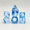 A set of seven blue translucent polyhedral gaming dice, including a tetrahedron and a cube.
