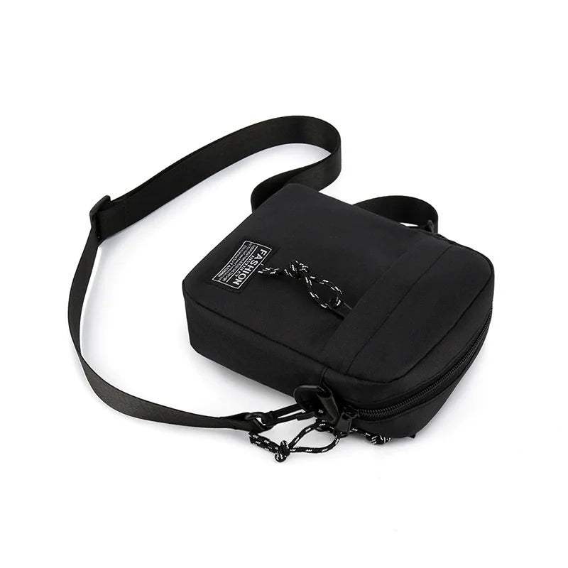 Black mini crossbody phone bag with an adjustable strap shown against a white background.