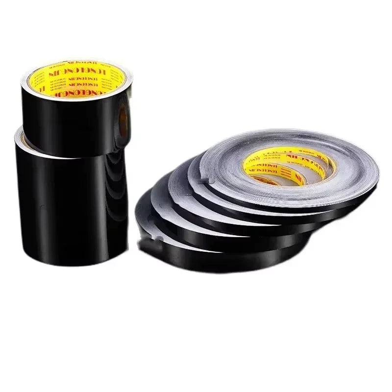 Rolls of black self-adhesive waterproof tile gap sealing tape stacked on a white background.
