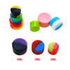 A set of colorful flexible silicone travel jars in various sizes including 5ML, 3ML, and 2ML.