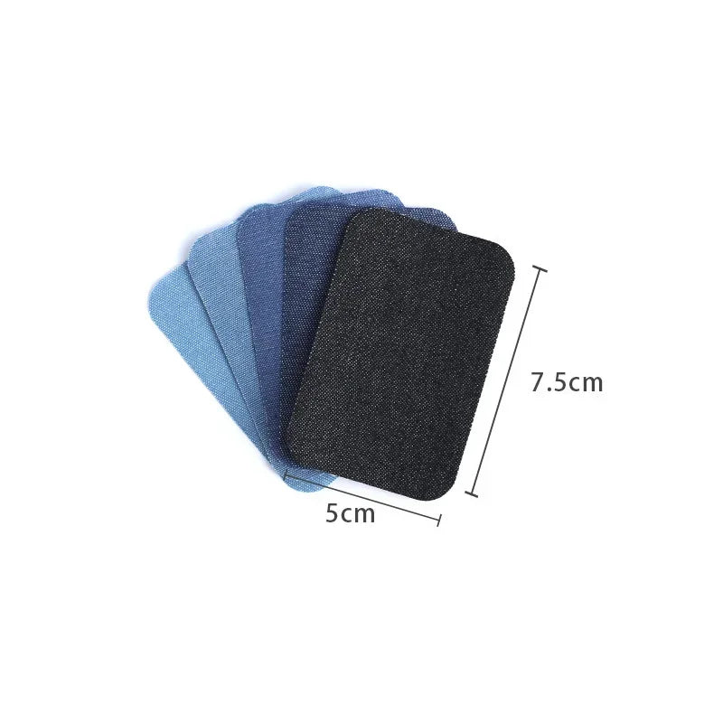 A stack of dark blue and black iron-on patches for denim repair and decoration.