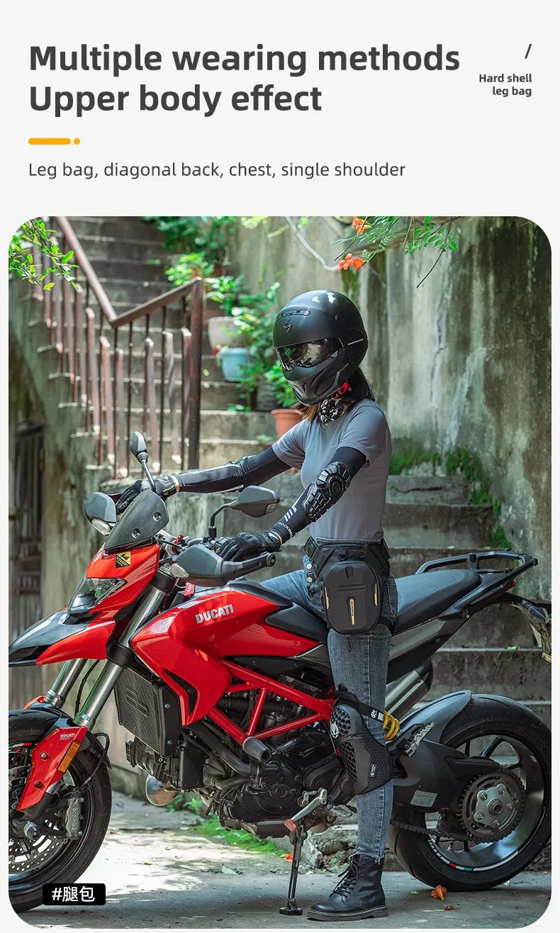 A person wearing a black helmet and leather gloves sits on a red Ducati motorcycle with a black hip pack attached.