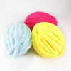 Three skeins of brightly colored chenille yarn in pink, light blue, and yellow stacked together.