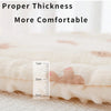 A close-up of a thick, padded fabric cushion demonstrating its thickness with a ruler for measurement.