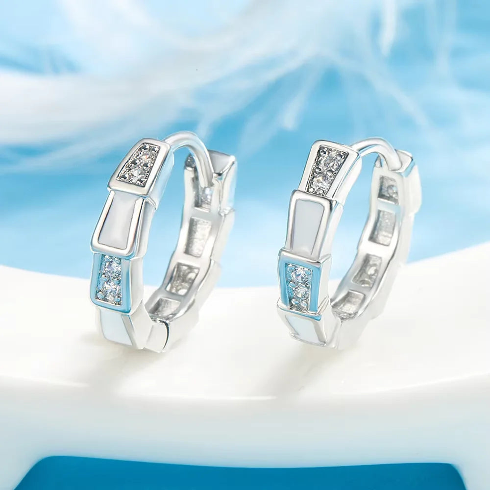 Pair of 925 sterling silver turquoise hoop earrings displayed against a light blue background.
