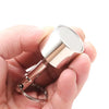 A hand holds a silver-colored neodymium magnet keychain with a detachable clasp.