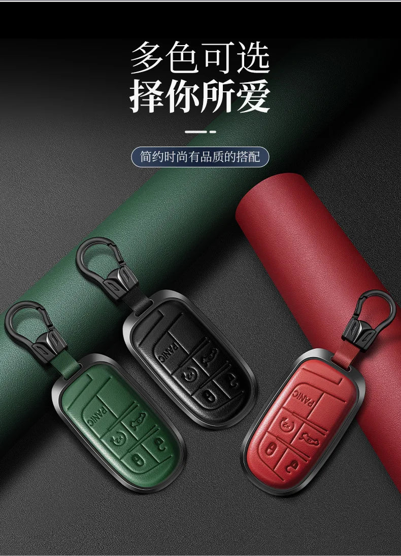 Three colored leather and metal car key cases displayed on a dark background.