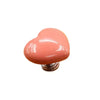A pink heart-shaped toilet flush button with a nail protector.
