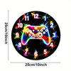A black wall clock face with a gaming controller design, showing numbers 1 through 12 around the perimeter.