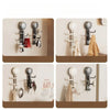 A set of modern, adjustable suction cup hooks in silver and white for kitchen and bathroom use.