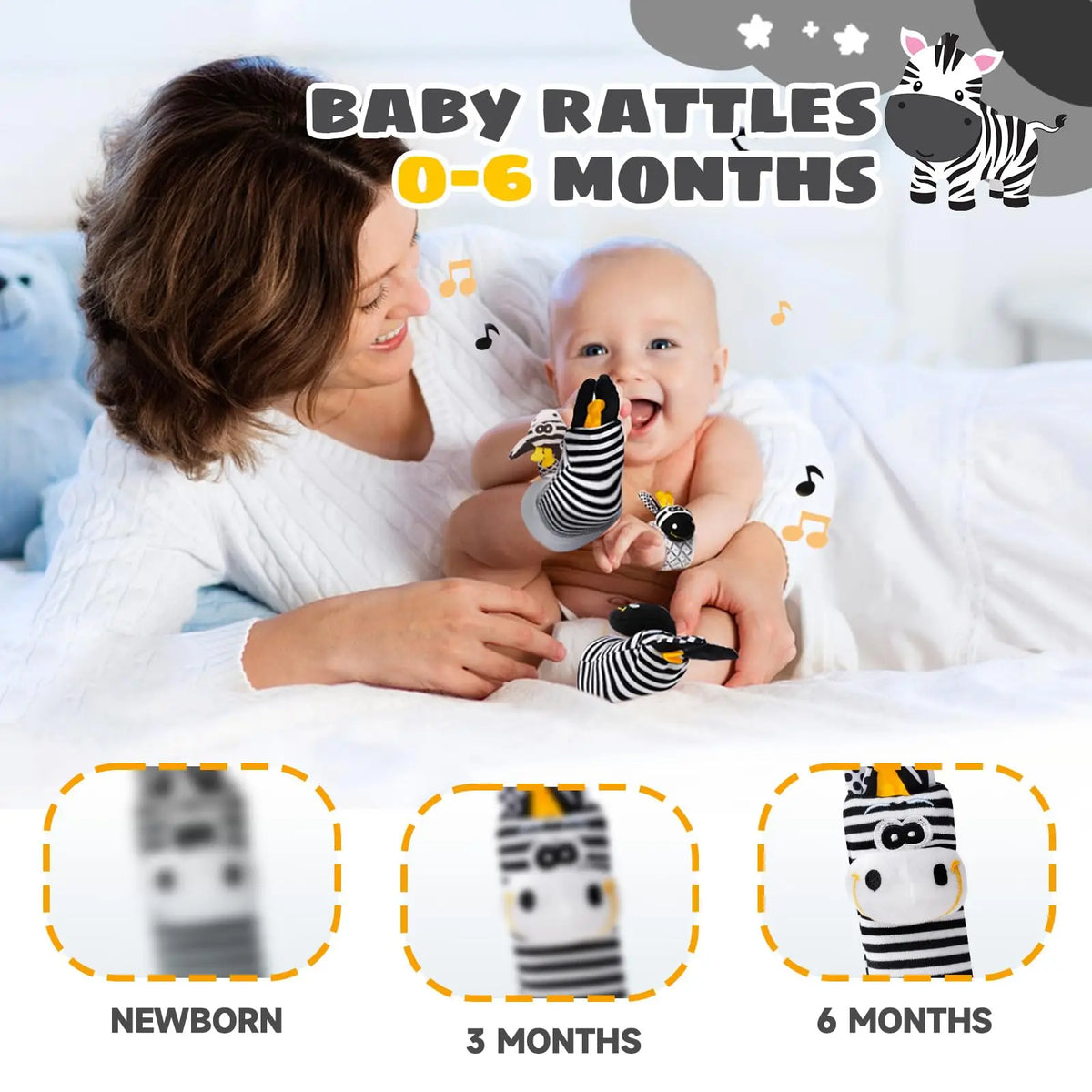 A smiling mother holds a baby wearing soft black and white striped wrist rattles in a bright, indoor setting.