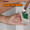 A hand is holding a green non-contact AC voltage detector pen against a white wall surface.