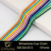 A close-up of a multi-color rhinestone cup chain featuring various shades of yellow, pink, purple, and green stones.