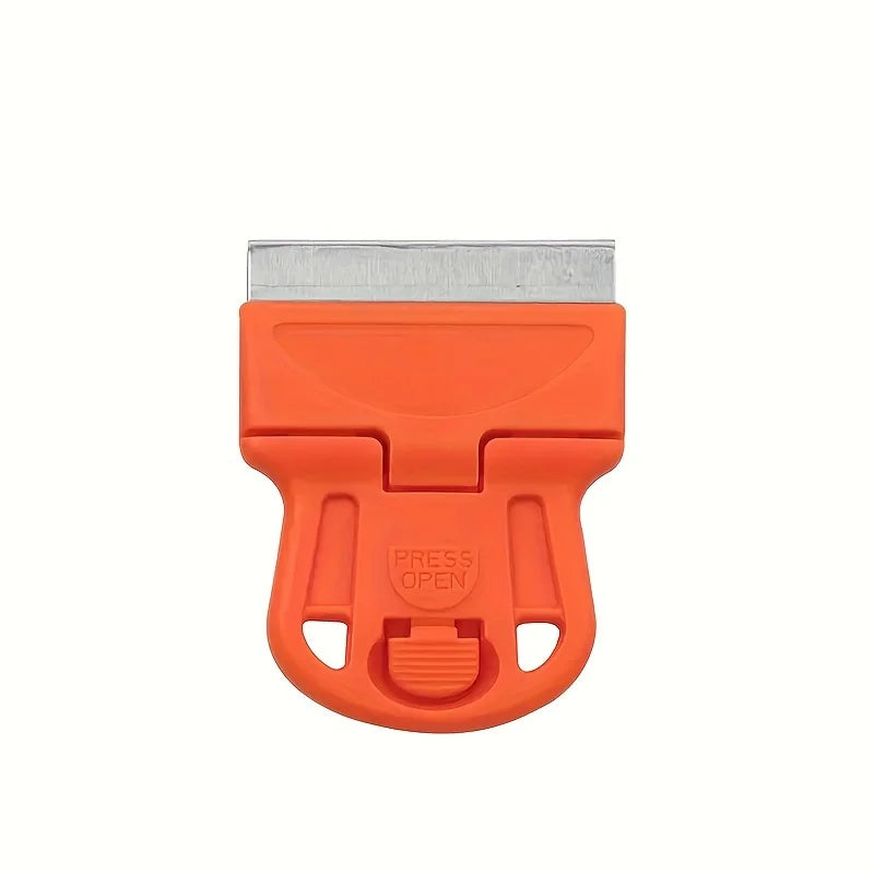 An orange compact multi-purpose scraper tool with a metal blade for removing stickers, glue, and paint.