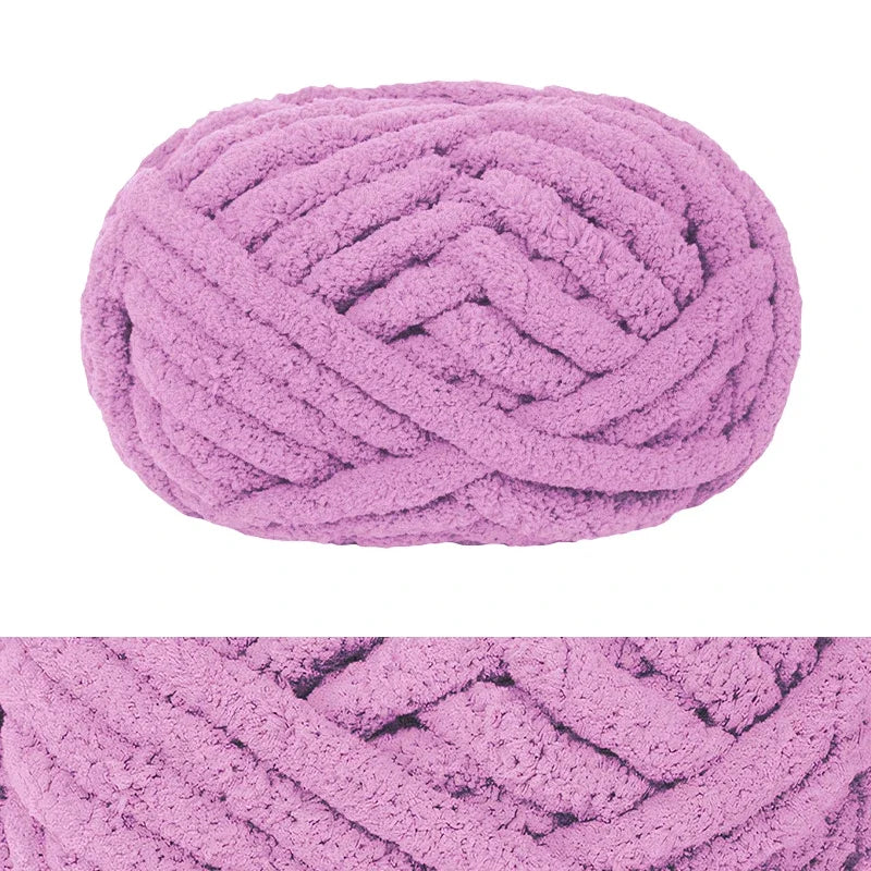 A ball of fluffy pink chenille yarn used for hand knitting and crochet