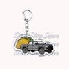 A silver metal key ring attached to a durable keychain featuring an off-road truck design.