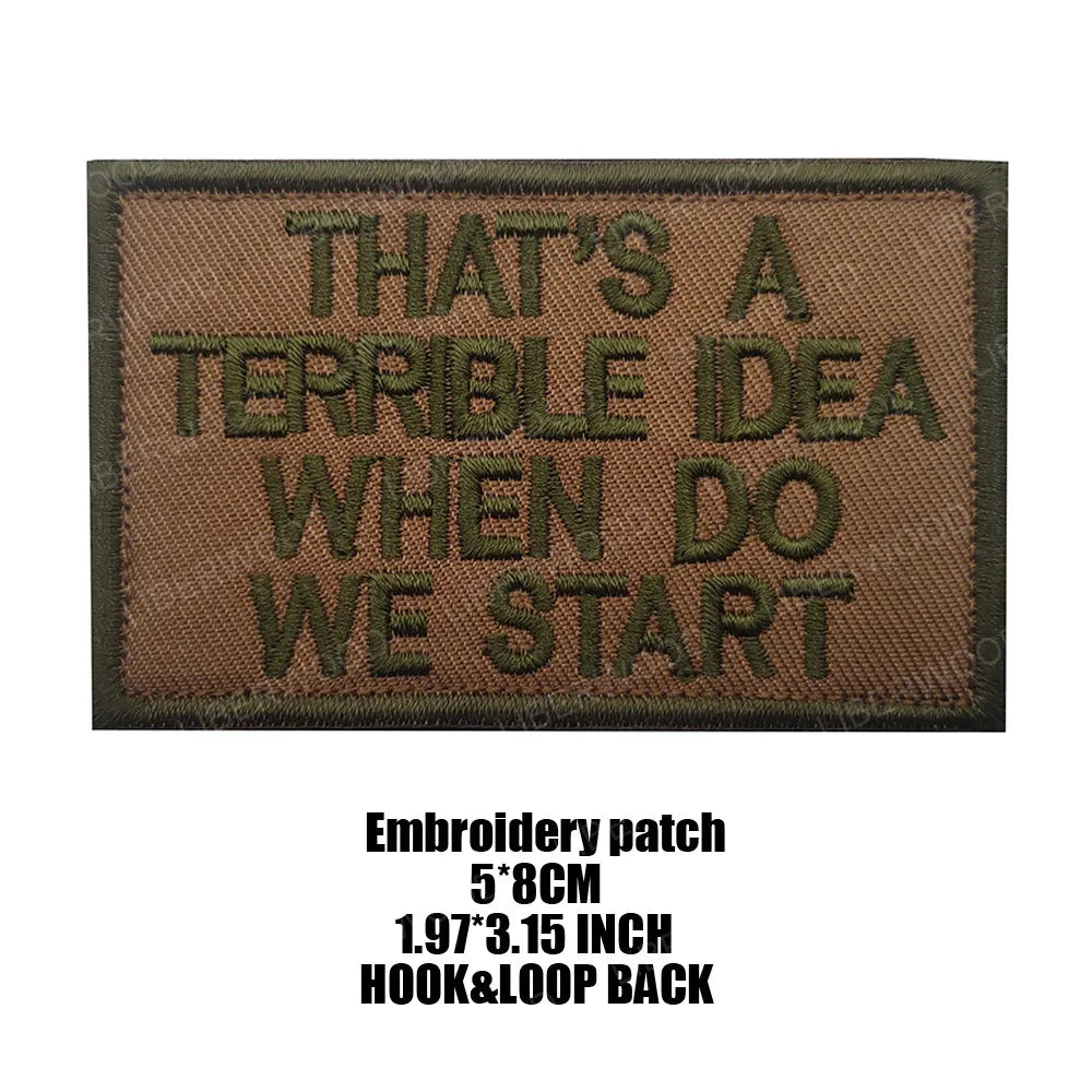 A dark brown embroidered patch with black text that reads THAT'S A TERRIBLE IDEA WHEN DO WE START